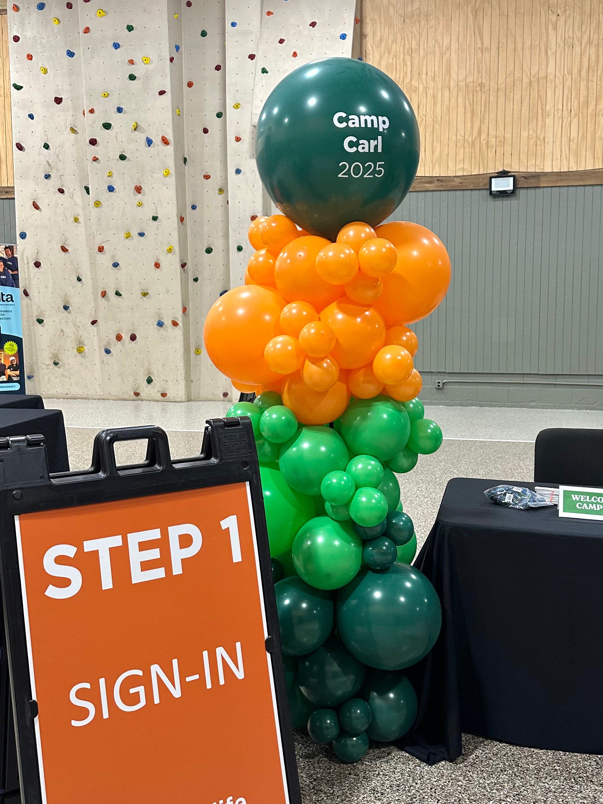 Balloon column with 'Camp Carl 2025' text.