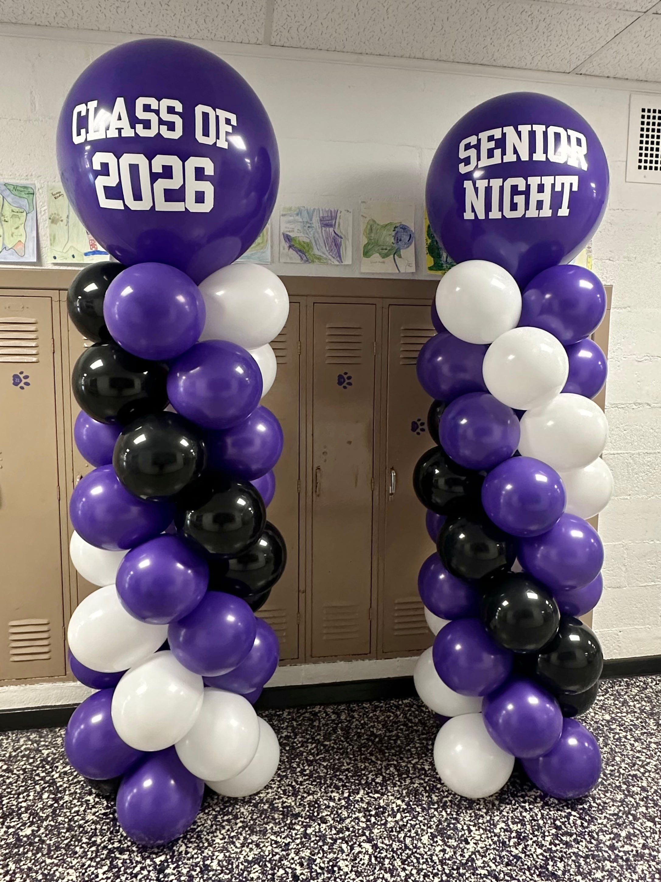 Purple, black, and white balloon towers with 'Class of 2026' and 'Senior Night' custom text.